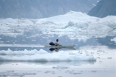 Nukagpianguaq, An Inuit hunter, out in his kayak in the ice strewn waters of Inglefield Bay. Northwest Greenland. 1980