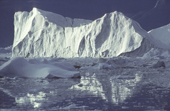 Icebergs float in a sea filled with broken ice off Greenland. NW Greenland. 1980