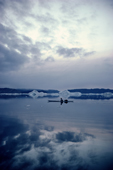 An Inuit hunter out in his kayak in the ice strewn waters of Inglefield Bredning, N.W. Greenland. 1980