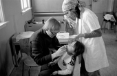 Danish dentist checks the teeth of Martha Peary, Siorapaluk. Northwest Greenland. 1977