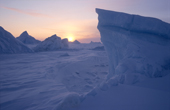 Icebergs in the frozen sea at sunset off the Greenland coast near savissavik. Northwest Greenland. 1998