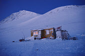 An Inuit hunter's wooden home during the winter dark time at Savissivik. Avanersuaq, Northwest Greenland. (1998)