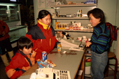 Inuit girls buy soft drinks and candy the shop in Savissivik. Northwest Greenland. 1998