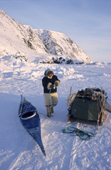 Inuit hunter, Qaerngak Nielsen, prepares to go hunting at the floe edge near Savissavik. Northwest Greenland. 1998