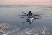 At -32 Celsius, an Inuit hunter paddles his kayak near Cape York. N.W. Greenland. 1998