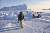 Simon Eliassen, an Inuit hunter, dressed in traditional polar bear trousers and boots, seal hunting at the floe edge near Cape York. Savissivik, Northwest Greenland. 1998