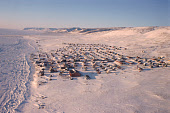 Aerial winter view of the Inuit settlement of Qaanaaq on the shore of Inglefield Bay. Thule, Northwest Greenland. (1998)