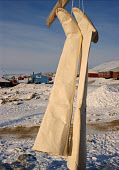 A pair of traditional Inuit women's long Kamik (sealskin boots) hang on a clothes line in Qaanaaq. Northwest Greenland. (1998)