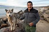 Thomas Qujaukitsoq, an Inuit hunter from Qaanaaq, with his sled dog 'Pluto'. Avanersuaq, Northwest Greenland