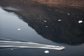 Aerial view of a motor boat and drifting icebergs in Bowdoin Fiord. Thule. Avanersuaq, Northwest Greenland
