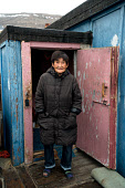 Saufak Kiviok, an elderly Inuit woman, outside her home in the community of Qaanaaq. Avanersuaq, Northwest Greenland