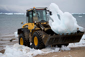 A front loader being used to collect glacial ice for the community's water supply in Qaanaaq. Northwest Greenland. 2008