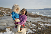 Sofie jensen, a young Inuit woman from Qaanaaq, with her son Nicklas. Both are wearing the traditional dress of the Avanersuaq region of Northwest Greenland. (2021)