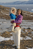 Sofie jensen, a young Inuit woman from Qaanaaq, with her son Nicklas. Both are wearing the traditional dress of the Avanersuaq region of Northwest Greenland. (2021)