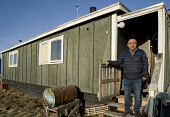 Kigutikkak Kivioq, an Inuit man, outside his home in Qaanaaq. Avanersuaq, Northwest Greenland.(2021)