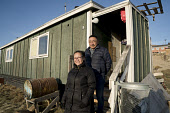 Kigutikkak Kivioq and his wife Naja, an Inuit couple, outside their home in Qaanaaq. Avanersuaq, Northwest Greenland.(2021)