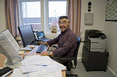 Panigpak Daorana, an Inuit man, in the office where he works as the head of administration in the settlement of Qaanaaq. Avanersuaq, Northwest Greenland. (2021)