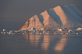 A view from Qaanaaq of the morning sun catching Herbert Island and icebergs nearby. Qaanaaq, Avanersuaq, Northwest Greenland. (2021)