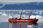 A Royal Arctic Line ship unloading containers with supplies at Qaanaaq in the summer. Northwest Greenland. (2022)