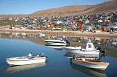 Inuit hunters' boats in the harbour at Qaanaaq during the summer. Northwest Greenland. (2022)