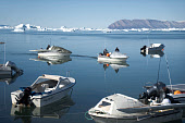Inuit hunters' boats in the harbour at Qaanaaq during the summer. Northwest Greenland. (2022)