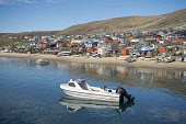 An Inuit hunter's boat in the harbour at Qaanaaq during the summer. Northwest Greenland. (2022)