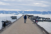 The Quay at the harbour in Qaanaaq with Inuit hunters' boats alongside. Northwest Greenland. (2022)