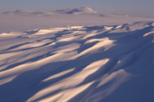 Sastrugi etched in the snow covered winter tundra near Lavrentiya. Chukotka, Siberia, Russia. 2002