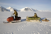 Yupik Eskimo hunters travelling to the floe edge by snowmobile with an inflatable boat. Tkachen Bay. Chukotskiy Peninsula, Chukotka, Siberia, Russia. 2010