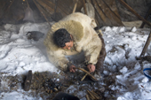 Grisha Rahtyn, a Chukchi reindeer herder, using a bow drill to make fire during a traditional ritual. Chukotskiy Peninsula, Chukotka, Siberia, Russia. 2010