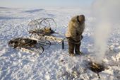 Grisha Rahtyn, a Chukchi reindeer herder, stands by a fire he has made with a bow drill for a traditional ritual. Chukotskiy Peninsula, Chukotka, Siberia, Russia. 2010
