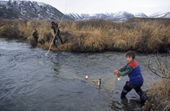 Chukchi boys checking a fish net on a small river near Khailino. Koryakia, Kamchatka, Siberia, Russia. 1999