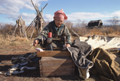 An elderly Even woman sewing a tent at a camp near Khailino. Koryakia, Kamchatka, Siberia, Russia. 1999