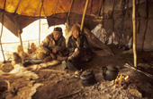 Tatko, an elderly Koryak man, with his Even wife Raisa, inside their Yurt at a camp near Khailino. Koryakia, Kamchatka, Siberia, Russia. 1999