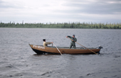 Sami men set out in a wooden boat to check their fishing nets near Lovozero (strong Lake). Kola Peninsula, NW Russia. 2005