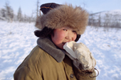 Misha Elrika, an Even boy, enjoys an ice cream at -35 Celsius. Northern Evensk, Magadan Region, Eastern Siberia, Russia. 2006
