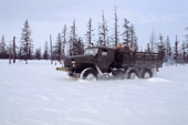 An Ural truck carrying supplies through deep snow on a winter road in Northern Evensk, Magadan Region, E. Siberia, Russia. 2006