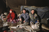 Even reindeer herders, Vitally & Ulita Elrika with Vassily Minaev, inside their tent at a winter camp in N. Evensk, Magadan Region, E. Siberia, Russia. 2006