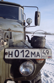 During tea break on a journey by winter road a kettle rests on an Ural truck.Evensk, Magadan Region, E.Siberia, Russia. 2006