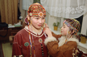 Young girls from a Koryak dance group put the finishing touches to their costume. Evensk, Magadan Region, E. Siberia, Russia. 2006