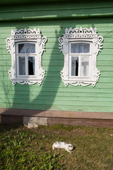 A cat sleeps in the afternoon sunshine outside a wooden house in Pogost. Ryazan Province, Russia. 2006
