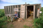 Gallina Zevina, an elderly Nivkhi woman, sitting outside her summer hut at Niva Bay. Sakhalin Island, Russian Far East. 2006