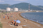 Bathers on the beach at Pregorodnaye where Sakhalin Energy's Liquid Natural Gas processing facility is under construction. Sakhalin Island, Russian Far East. 2006