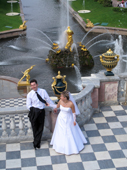 Wedding couple, with golden fountains and the Great Canal behind. Peterhof Palace. Near St. Petersburg, Russia. 2010
