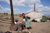 Tuvan woman cooking at Goat herder's Yurt out on the steppe. Republic of Tuva, Siberia. 1998