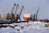 A container ship being unloaded in the docks at Dudinka during the winter. Taymyr, Northern Siberia, Russia. 2004