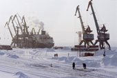A cargo ship being unloaded in the docks at Dudinka during the winter. Taymyr, Northern Siberia, Russia. 2004