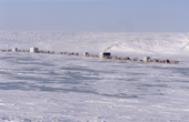 Dolgan reindeer herders move their camp of baloks (huts on sled runners) across a frozen lake during the winter. Taymyr. Northern Siberia, Russia. 2004