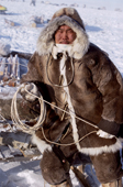Nikolai, a Dolgan reindeer herder holding a lasso rests against a sled during a reindeer round up. Taymyr, Northern Siberia, Russia. 2004