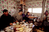 A Dolgan family of reindeer herders having a meal together inside their balok (a moveable hut built on sled runners). Taymyr, Northern Siberia, Russia. 2004